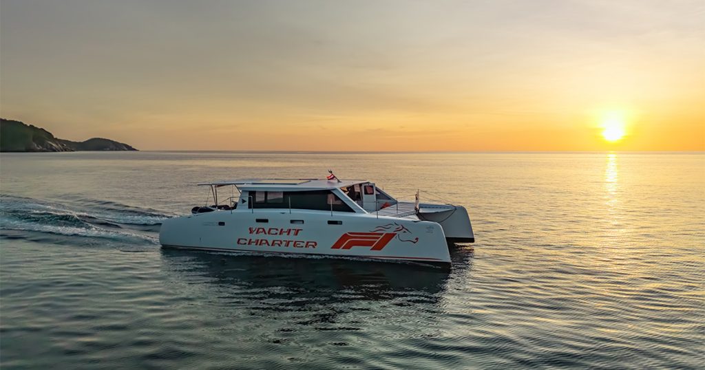 A picture of a Power Catamaran when the sun is setting.