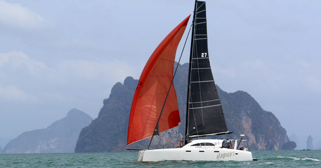 Stealth 13.2C Haruki sailing near limestone cliffs Bay Regatta Thailand