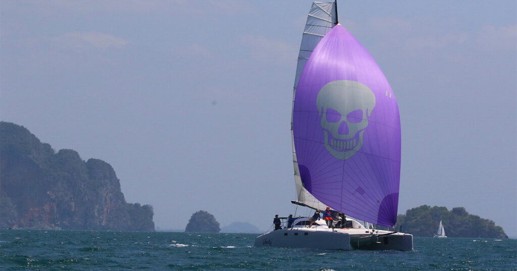 Stealth 13S Liberty V racing under purple spinnaker Bay Regatta Thailand