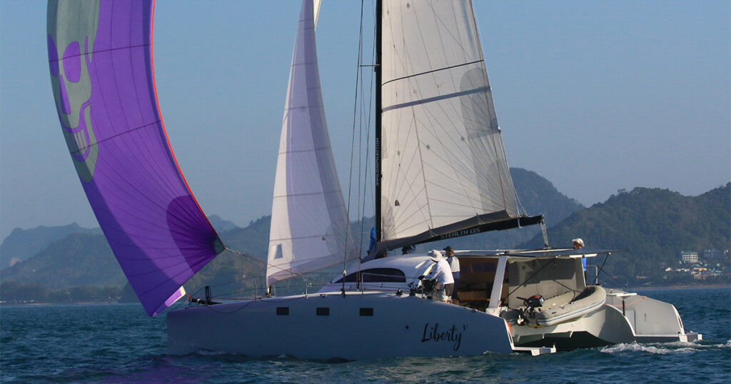 Stealth 13S Liberty V under spinnaker Bay Regatta Thailand
