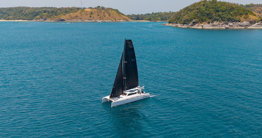 lightweight Stealth 13.2 catamaran sailing black mainsail