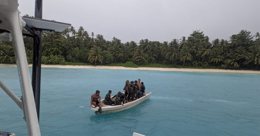 Local boat approaching Stealth catamaran Haruki during Sumatra cruise