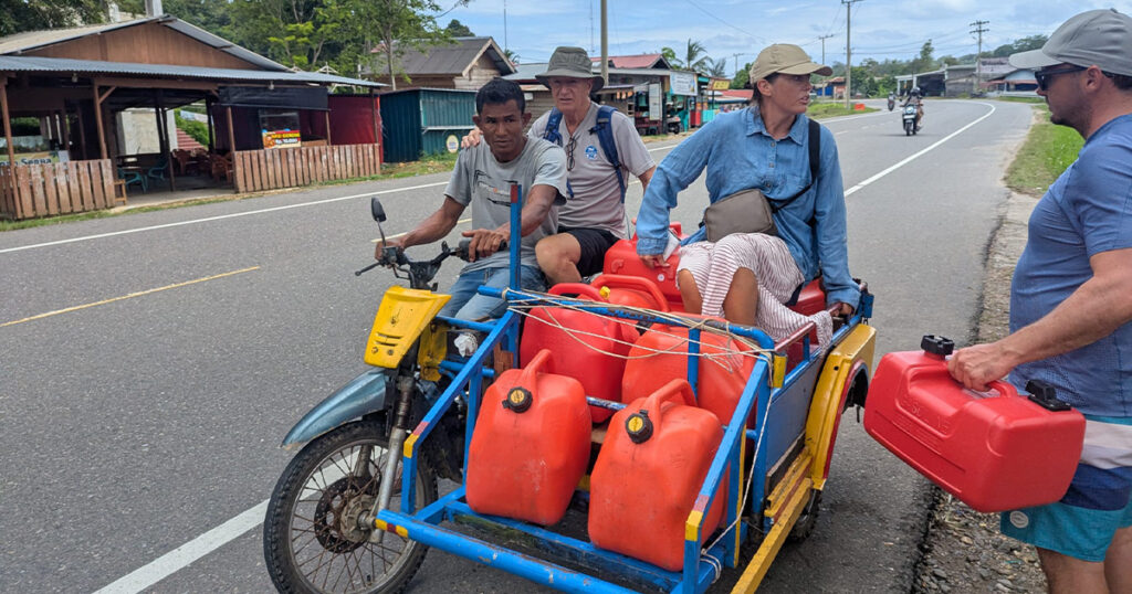 Supplying fuel by motorcycle cart during a remote Sumatra cruising stop