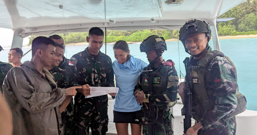 Local military personnel and crew onboard Stealth catamaran Haruki in Sumatra