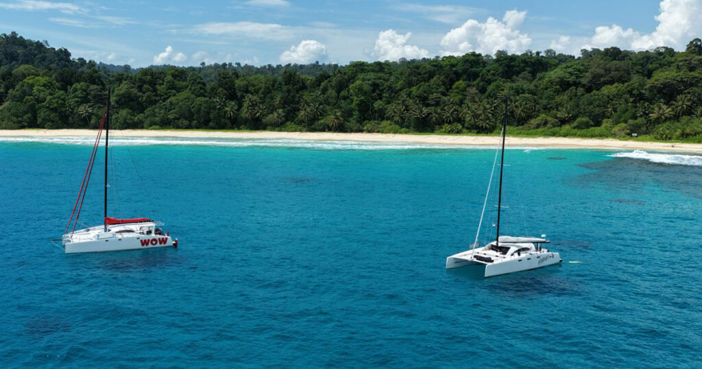 Stealth catamarans WOW and Haruki anchored off tropical beach in Sumatra