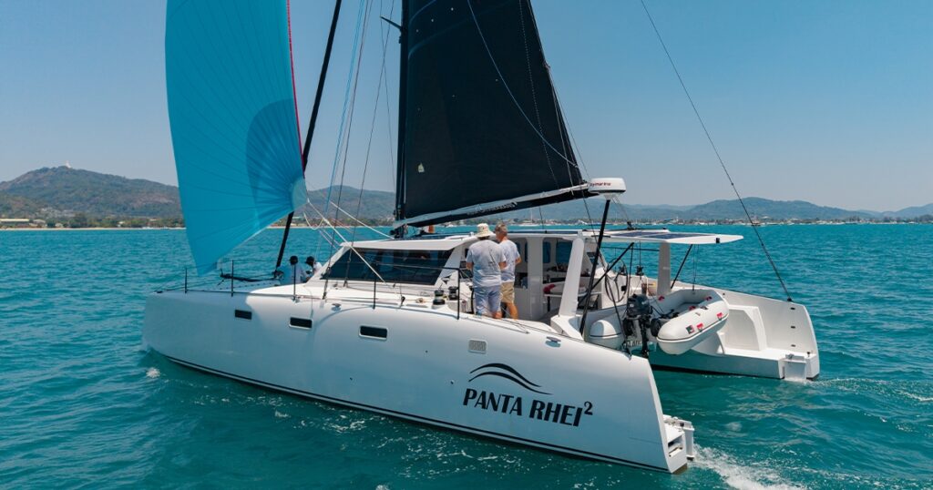 Panta Rhei² Stealth 13.2 catamaran sailing under blue spinnaker in Phuket