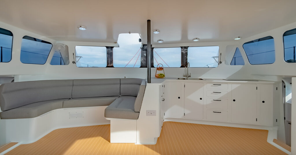 Saloon and galley interior of Stealth 13S performance catamaran